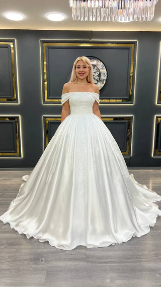 Opulent Off-the-Shoulder Princess Ball Gown Wedding Dress with Pearl Embellishments