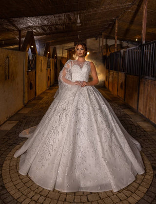 Radiant Crystal-Embellished Ball Gown Wedding Dress with Sheer Illusion Bodice and Dramatic Beaded Cape