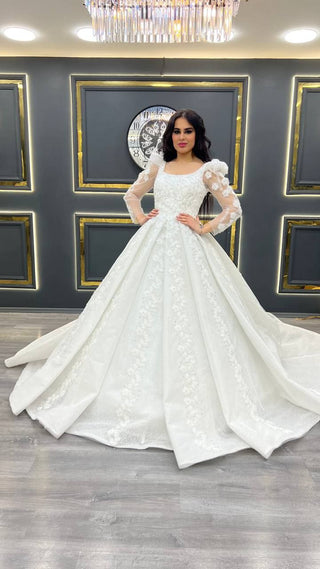 Exquisite Beaded Wedding Gown with Sheer Long Sleeves and Floral Detailing