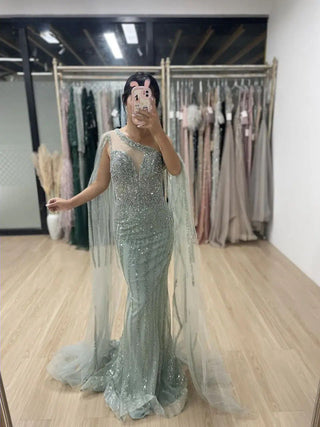 Ships in 1 to 3 Days - 2024 Green One-Shoulder Mermaid Evening Gown - Elegant Beaded Dress with Cape Sleeves for Women’s Wedding Guests and Parties